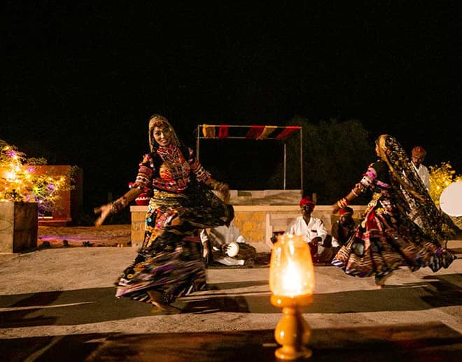 Performers in traditional Rajasthani dress dancing at a cultural evening