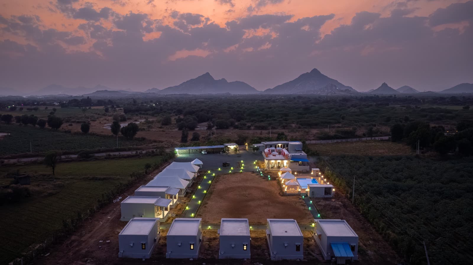 Upvan Jawai from the air at dusk, with the granite hills of Jawai rising behind it